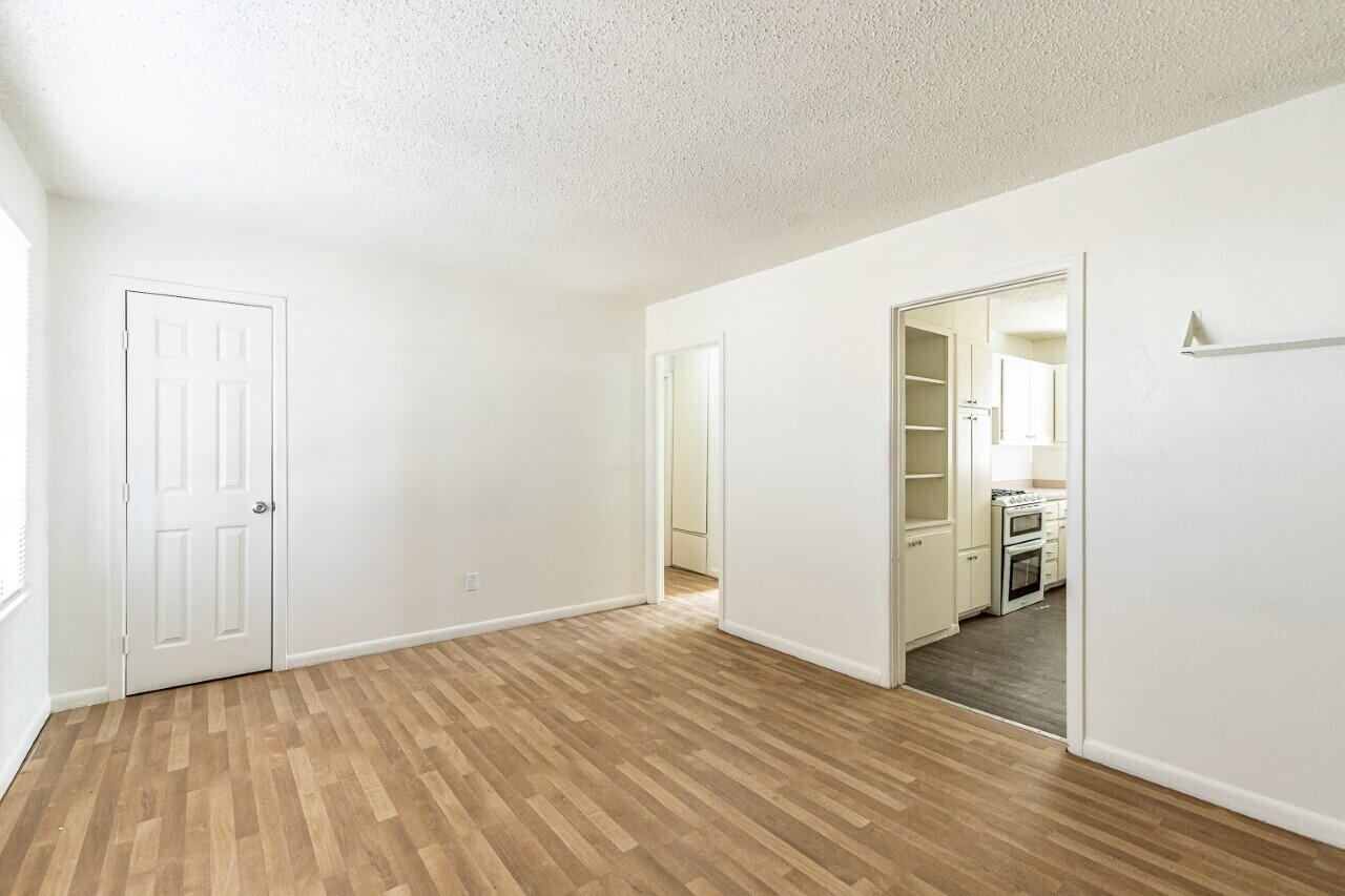 4823 35th Street Lubbock, TX 79414 - Photo 2 of 8 a view of an empty room with wooden floor