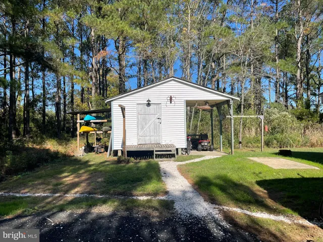 a view of a house with backyard sitting area and garden