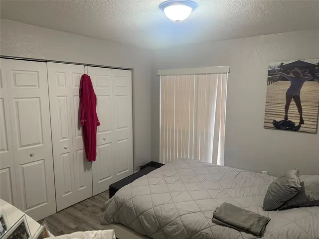a bedroom with a bed and a closet