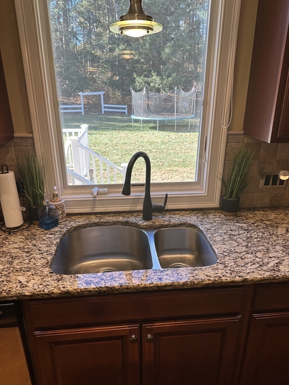 329 Forest Hills Road Springfield, MA 01128 - Photo 15 of 42 a kitchen with a granite countertop sink and a window