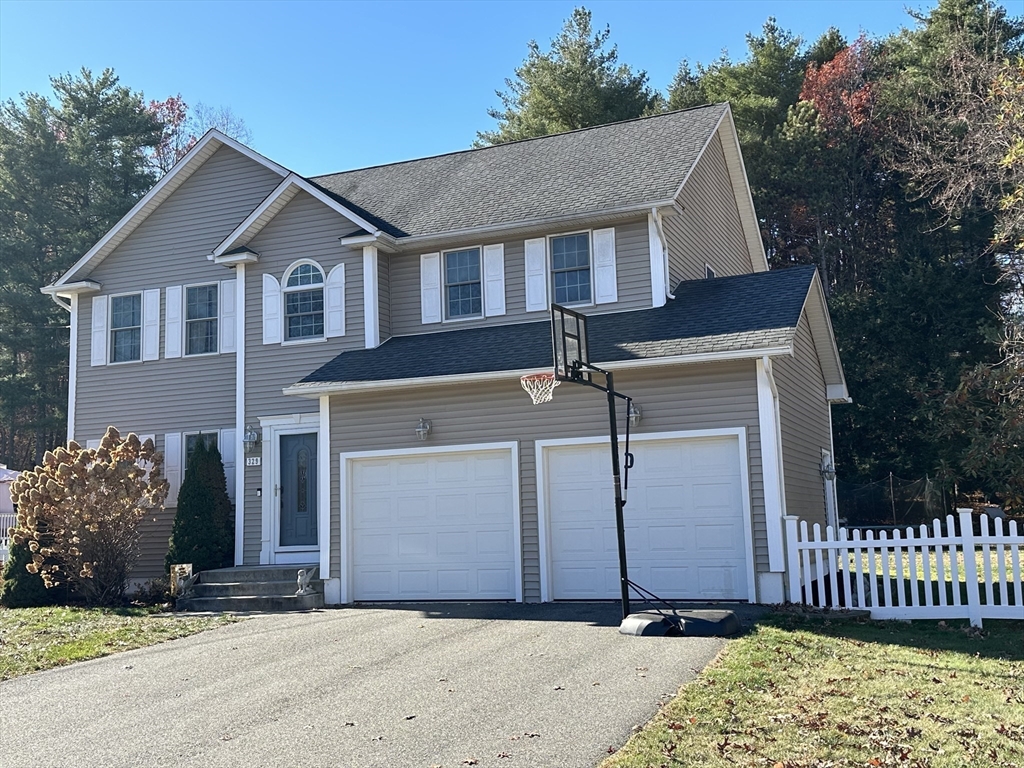 329 Forest Hills Road Springfield, MA 01128 - Photo 2 of 42 a front view of a house with a yard and garage