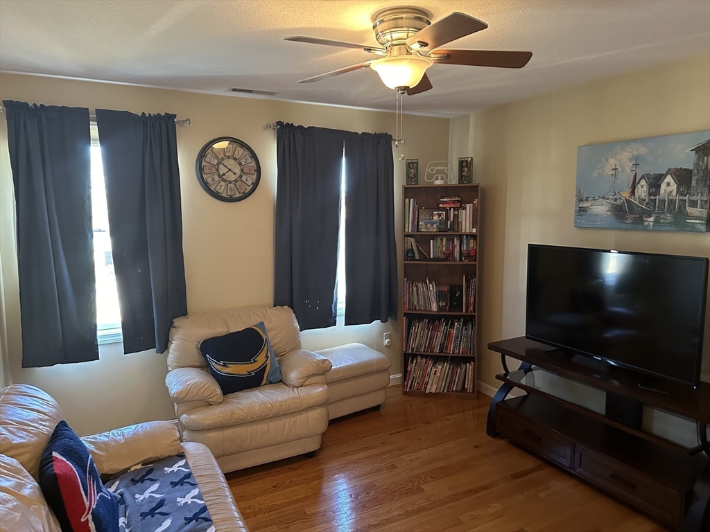 329 Forest Hills Road Springfield, MA 01128 - Photo 36 of 42 a living room with furniture and a flat screen tv