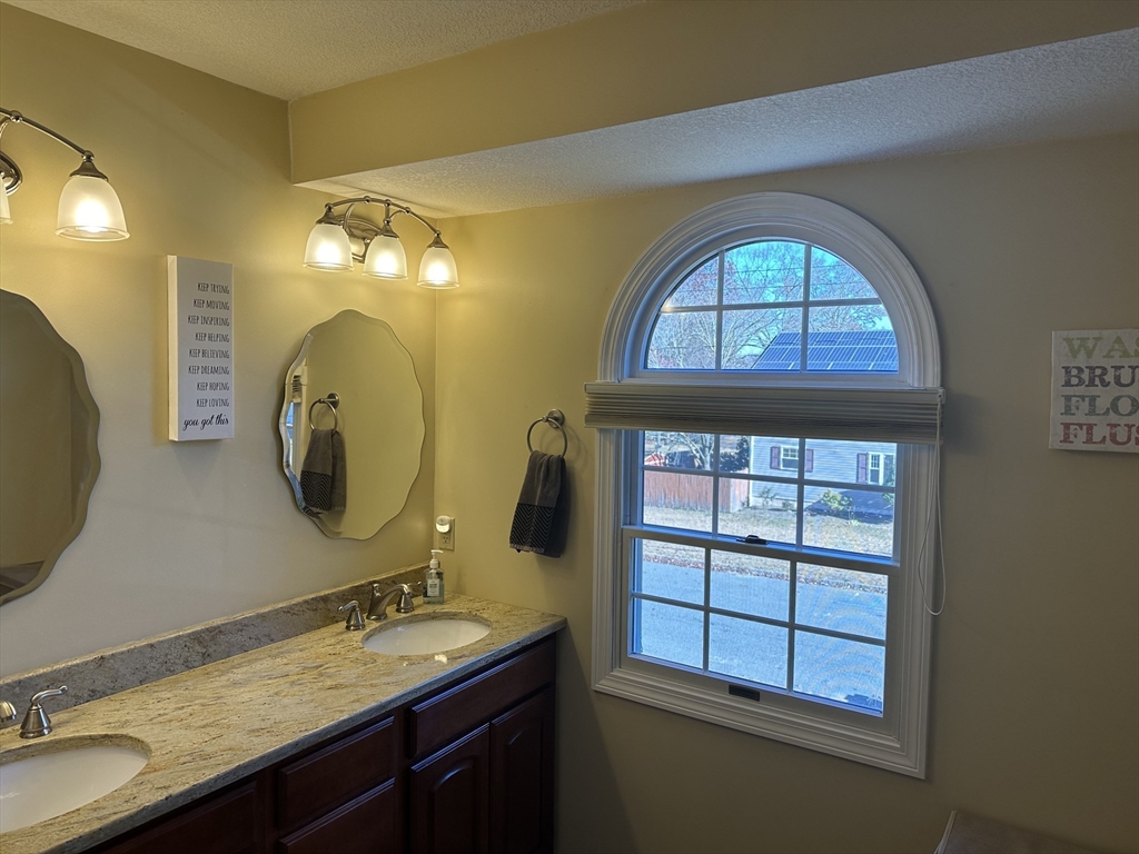 329 Forest Hills Road Springfield, MA 01128 - Photo 39 of 42 a bathroom with a double vanity sink and a mirror