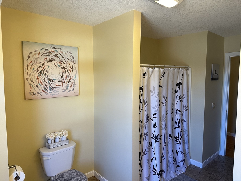 329 Forest Hills Road Springfield, MA 01128 - Photo 41 of 42 a bathroom with a toilet and a shower curtain