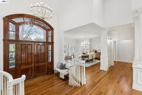 a living room with furniture large window and fireplace