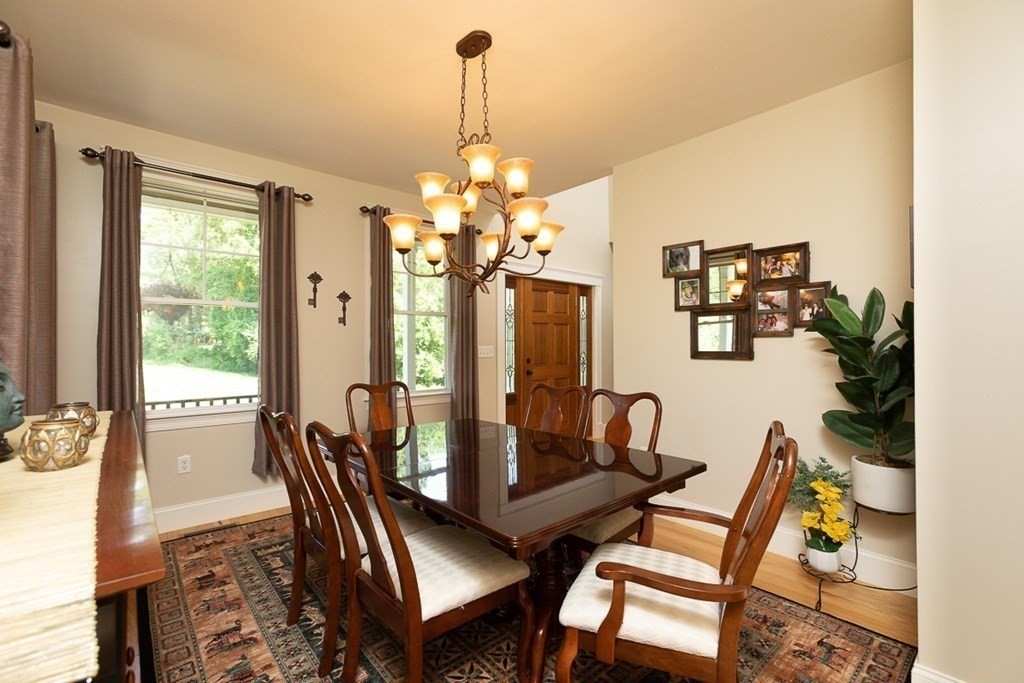 237 Newbury Road Rowley, MA 01969 - Photo 11 of 36 a view of a dining room with furniture a chandelier and wooden floor