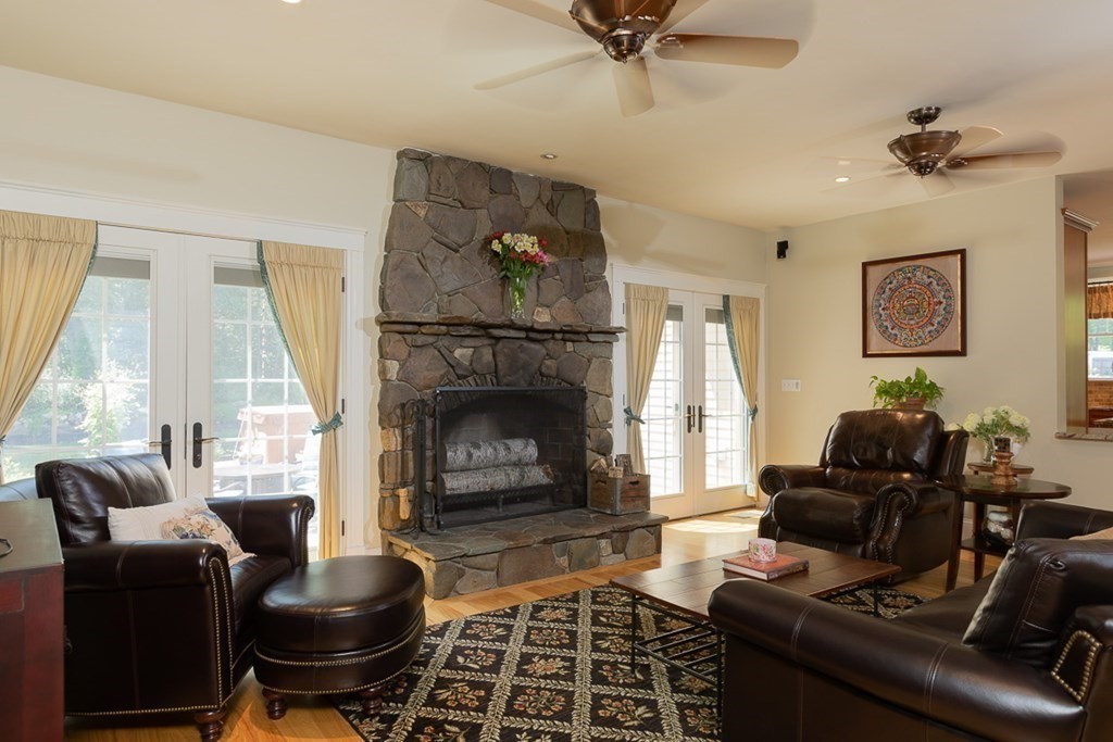 237 Newbury Road Rowley, MA 01969 - Photo 16 of 36 a living room with furniture and a fireplace
