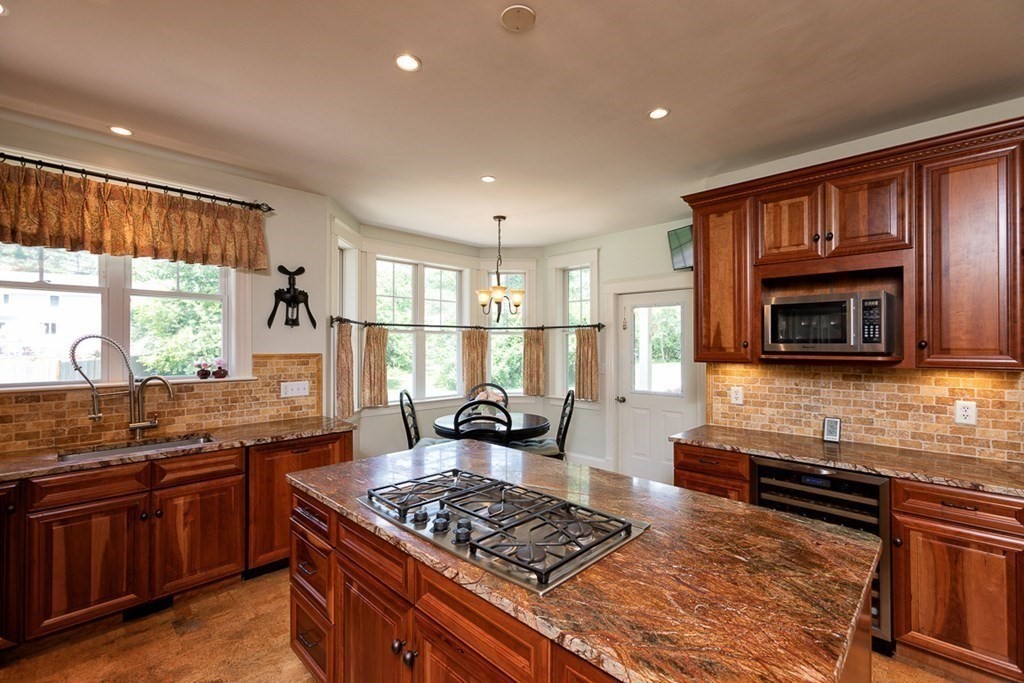 237 Newbury Road Rowley, MA 01969 - Photo 4 of 36 a kitchen with stainless steel appliances granite countertop a stove and a sink