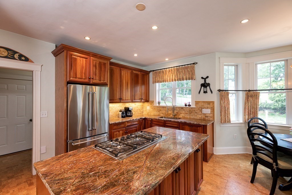 237 Newbury Road Rowley, MA 01969 - Photo 5 of 36 a kitchen with stainless steel appliances granite countertop a stove a refrigerator and a dining table