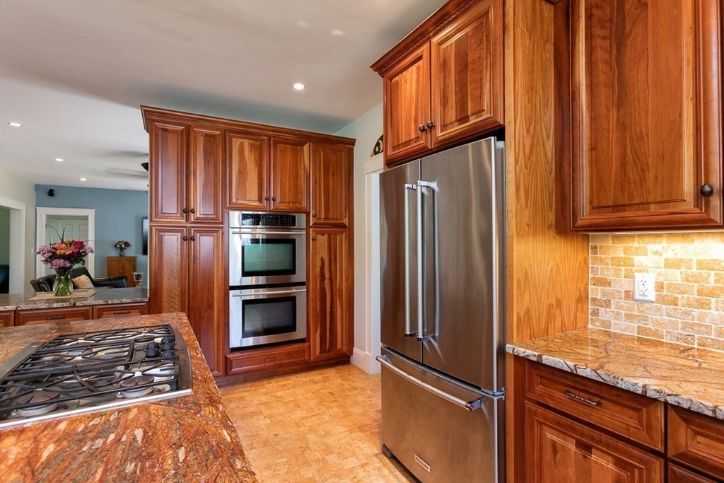 237 Newbury Road Rowley, MA 01969 - Photo 8 of 36 a kitchen with granite countertop stainless steel appliances a refrigerator and furniture