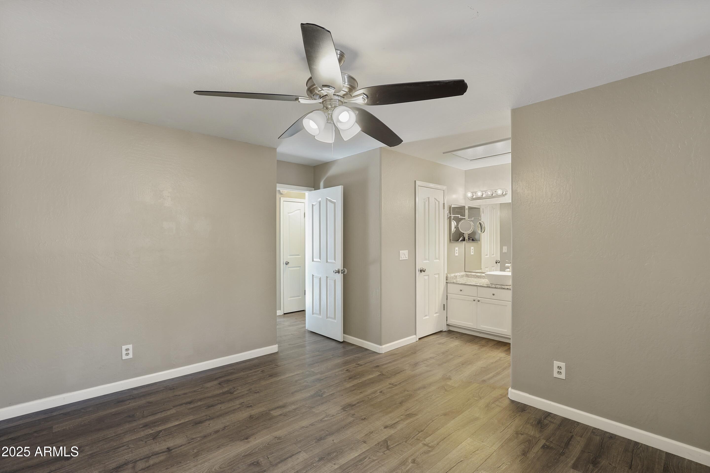 700 West Longhorn Road Payson, AZ 85541 - Photo 11 of 29 an empty room with wooden floor fan and windows