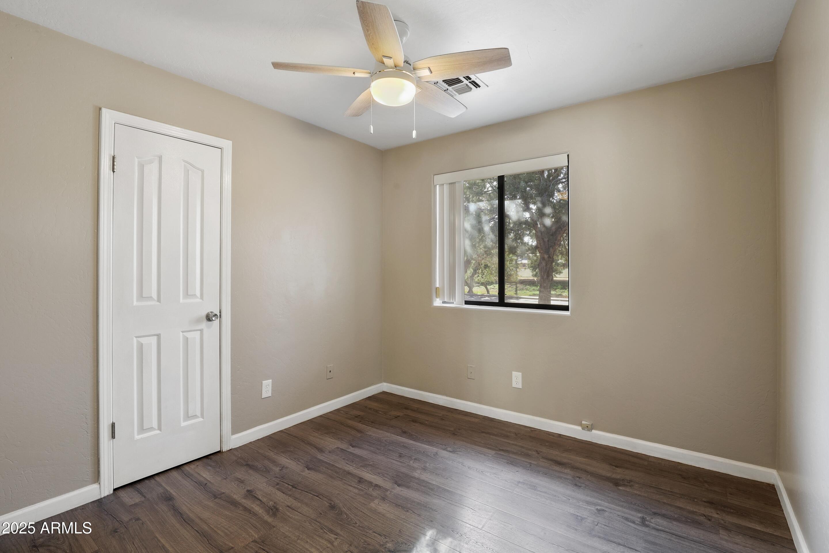 700 West Longhorn Road Payson, AZ 85541 - Photo 15 of 29 a view of an empty room with window and wooden floor