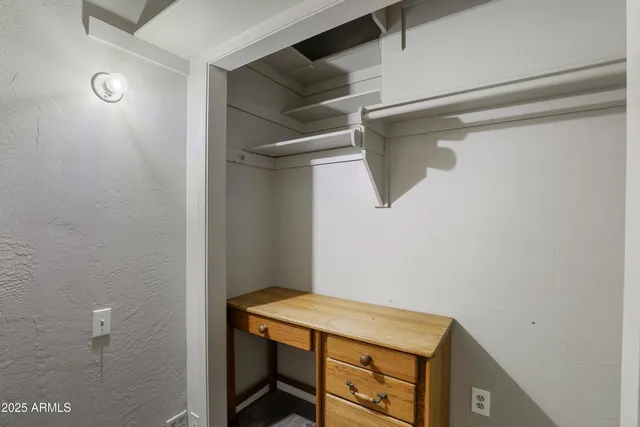a room with linen closet and wooden floor