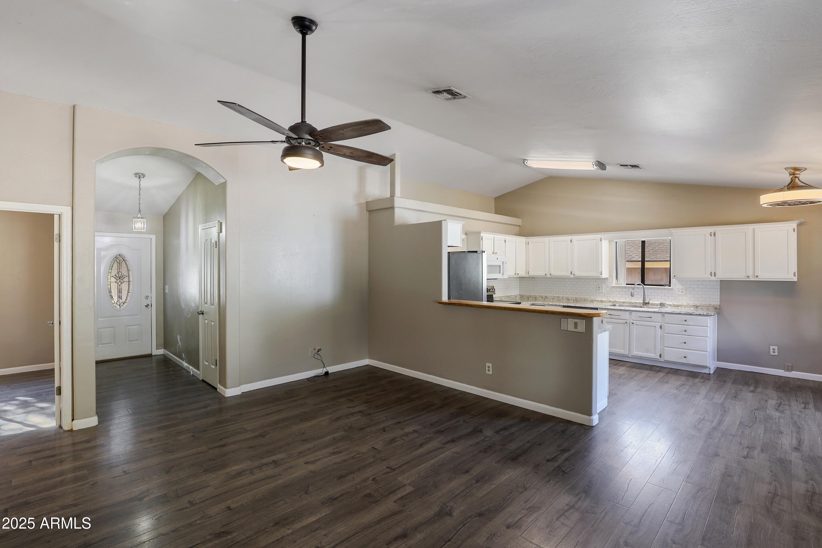 700 West Longhorn Road Payson, AZ 85541 - Photo 3 of 29 a kitchen with stainless steel appliances granite countertop a sink cabinets and wooden floor