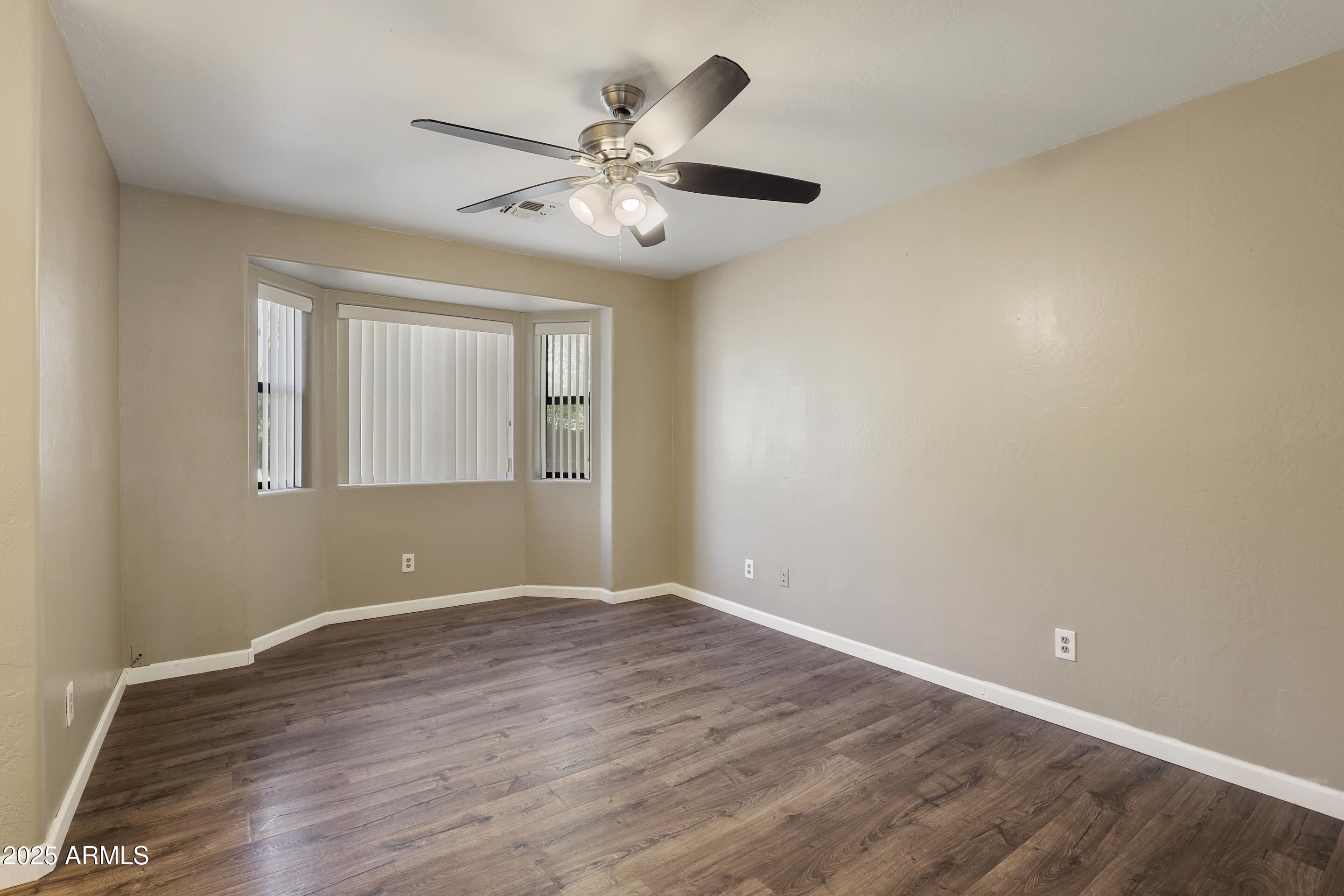 700 West Longhorn Road Payson, AZ 85541 - Photo 9 of 29 an empty room with wooden floor fan and windows