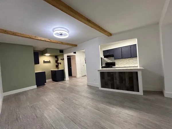 a view of kitchen with a sink and a refrigerator