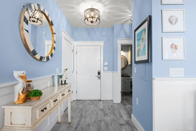 an entryway with wooden floor and a hallway