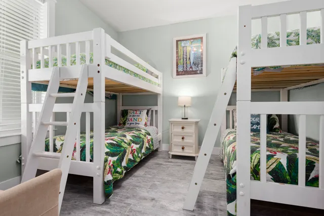 a bedroom with furniture and a large window