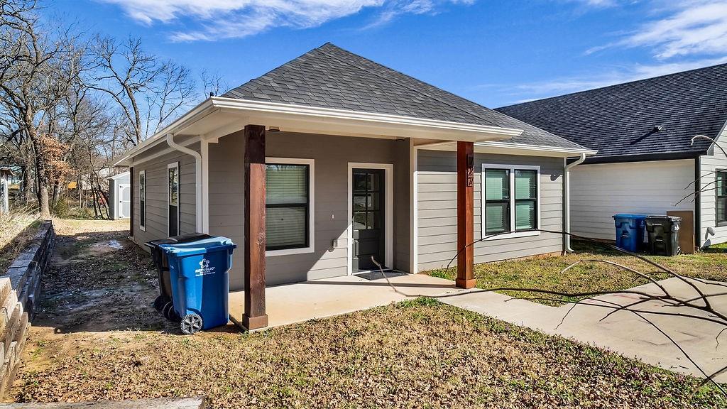a view of a house with basket chairs and floor to ceiling window