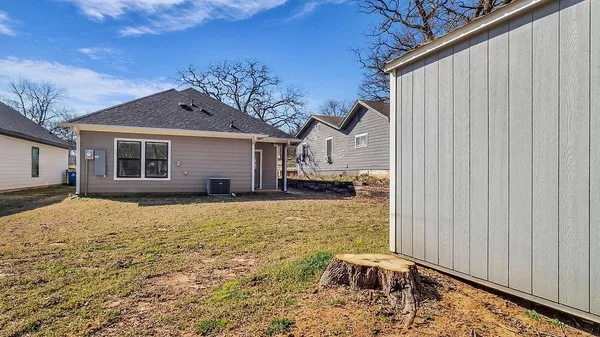 a backyard of a house with table and chairs