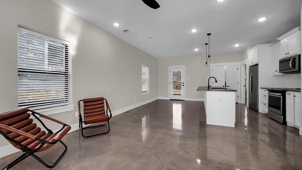 727 East Gandy Street Denison, TX 75021 - Photo 16 of 21 a view of kitchen with stainless steel appliances cabinets and a dining table