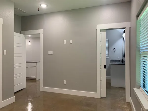 a bathroom with a granite countertop sink a mirror and a shower