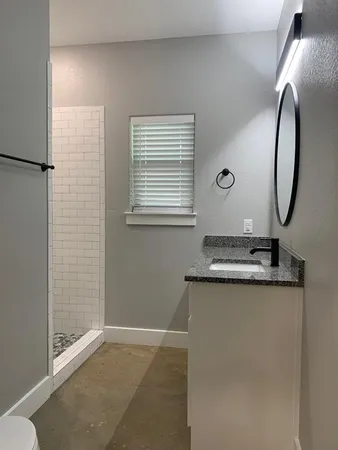 a bathroom with a shower and a window