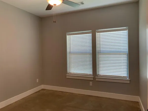 an empty room and closet with wooden floor