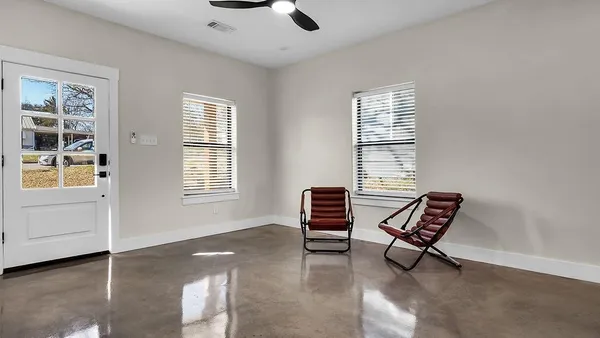a view of a livingroom with furniture and windows