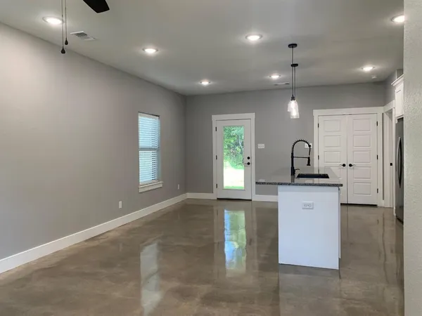a kitchen with stainless steel appliances granite countertop a sink a stove and microwave