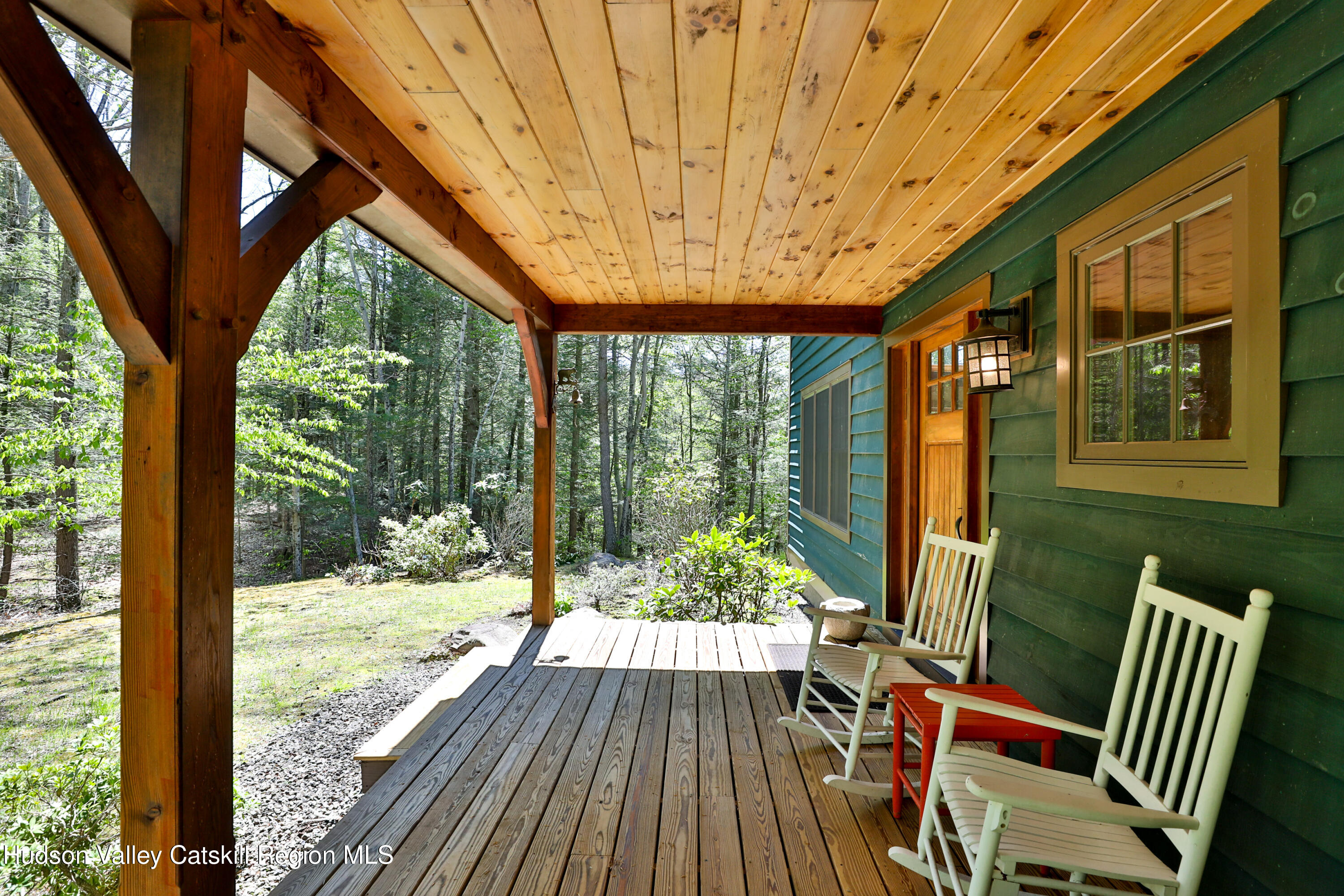 29 Fichtner Road Phoenicia, NY 12464 - Photo 11 of 64 a view of porch with a table chairs and wooden fence