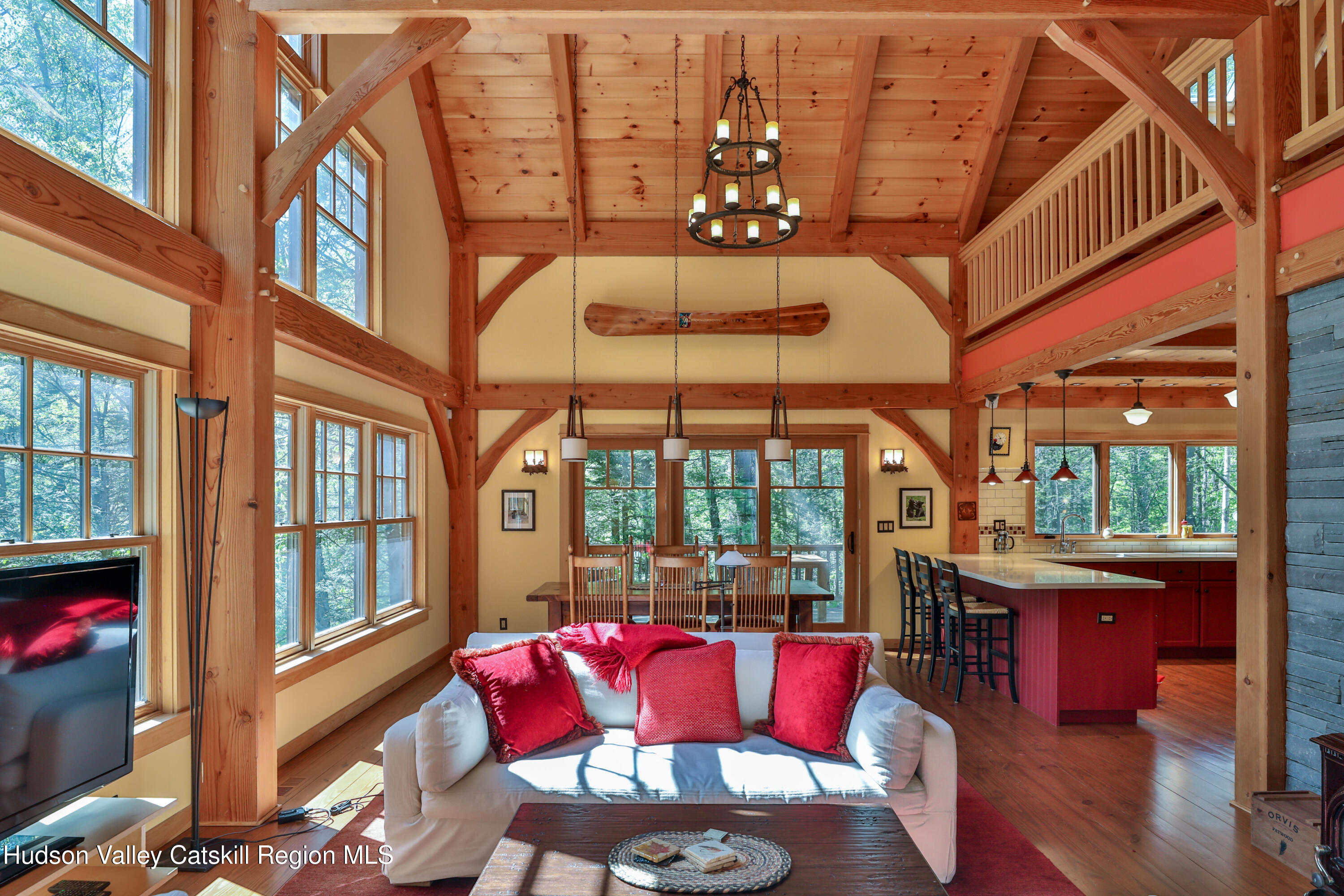 29 Fichtner Road Phoenicia, NY 12464 - Photo 33 of 64 a view of a dining room with furniture a chandelier and wooden floor