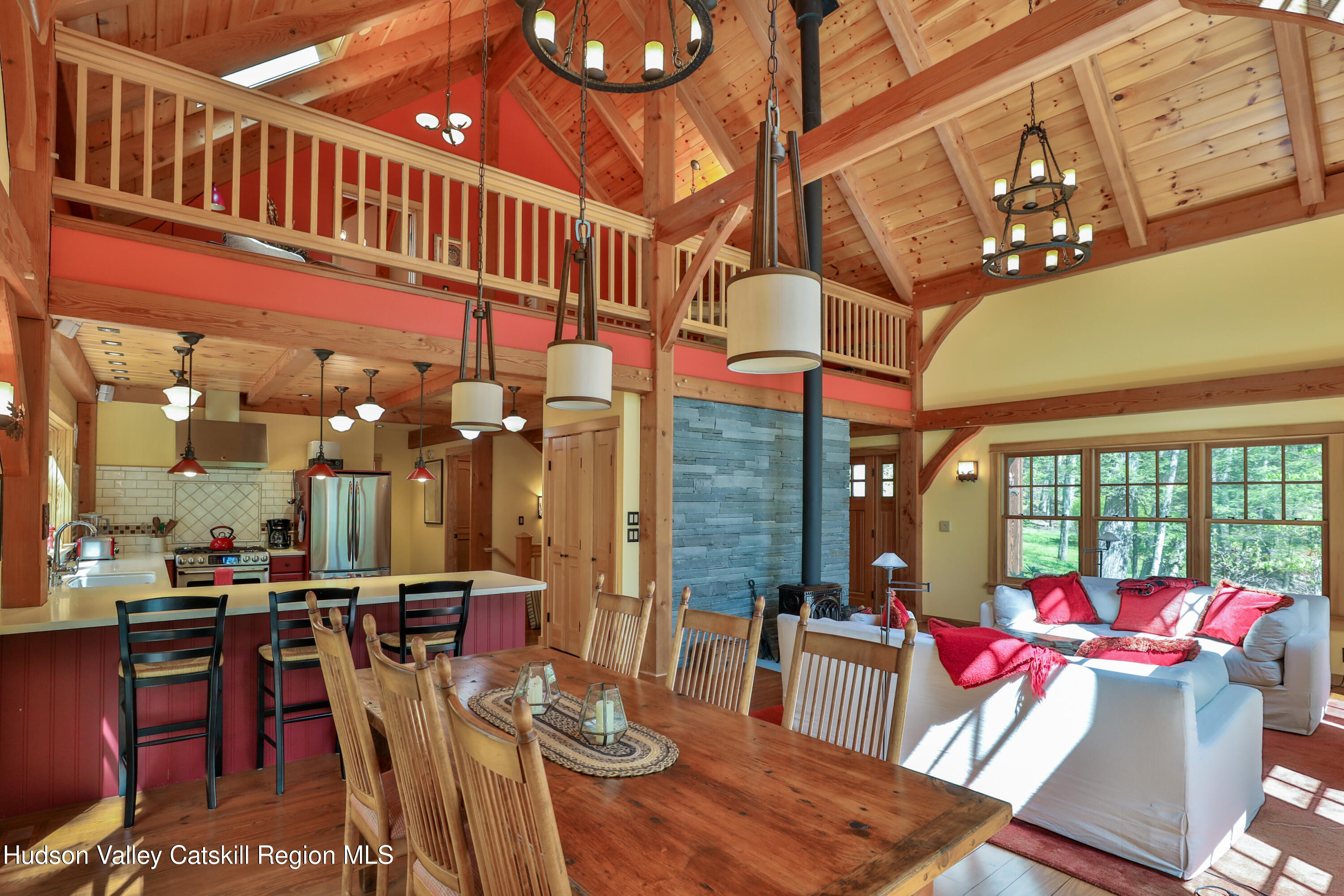 29 Fichtner Road Phoenicia, NY 12464 - Photo 36 of 64 a view of a dining room with furniture a chandelier and wooden floor