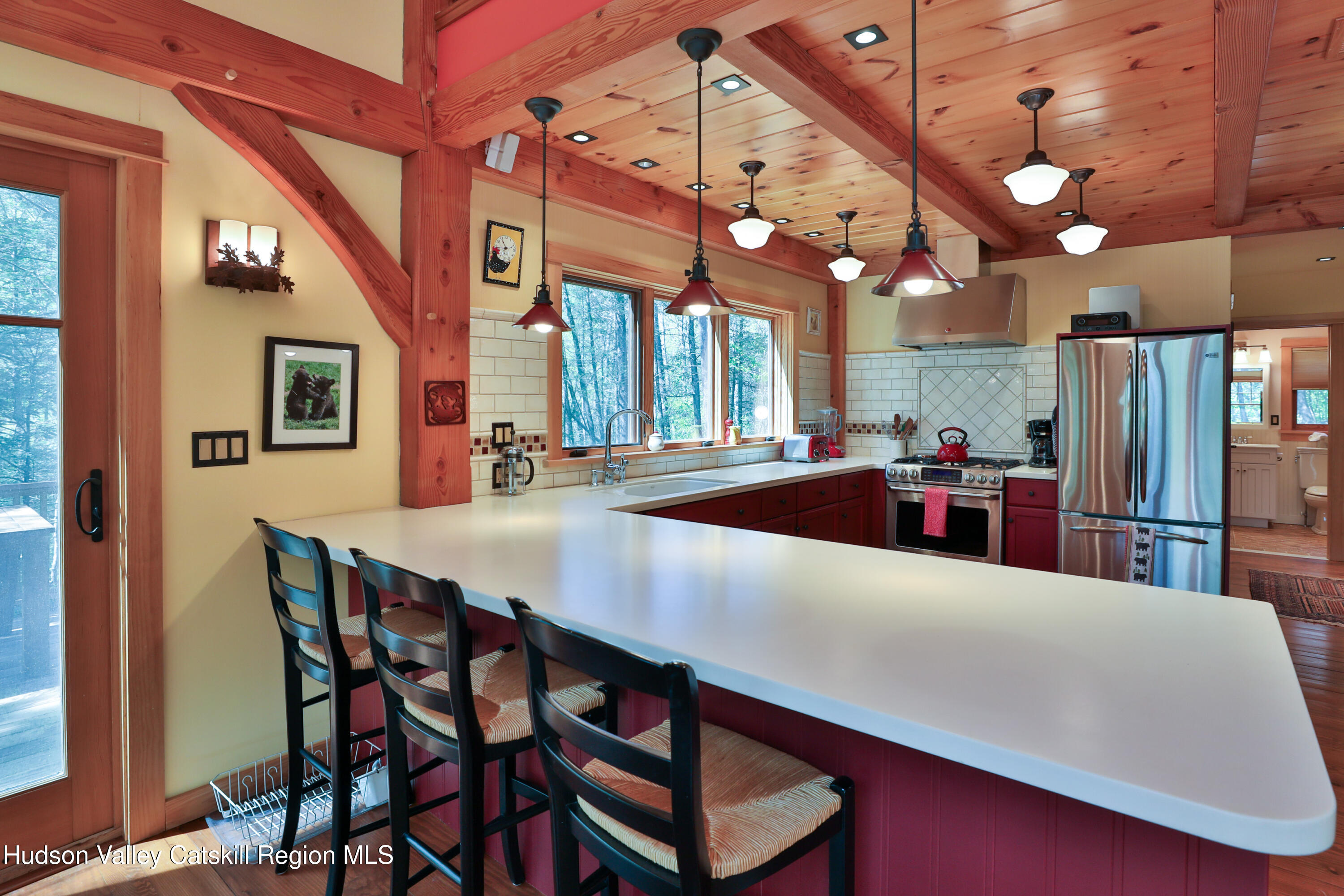 29 Fichtner Road Phoenicia, NY 12464 - Photo 5 of 64 a kitchen with stainless steel appliances a table chairs and chandelier