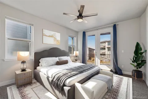 a bedroom with a large bed and a chandelier