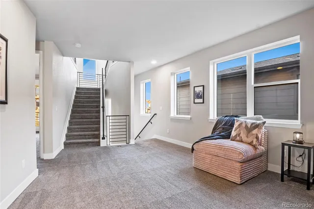 a living room with furniture and stairs