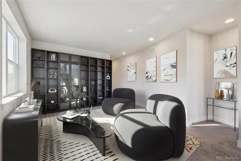 a living room with furniture and a floor to ceiling window