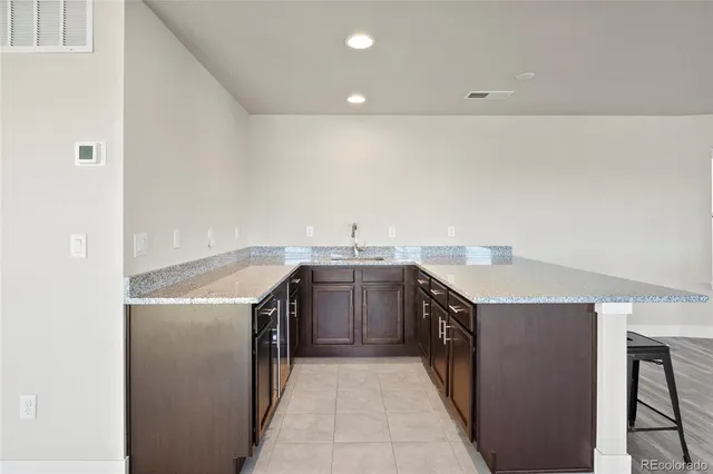 a kitchen with a stove top oven and sink