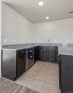 a kitchen with stainless steel appliances granite countertop a stove a refrigerator and a sink