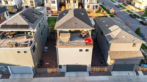 an aerial view of multiple houses with a yard
