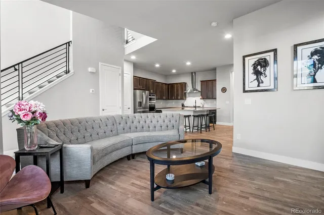 a living room with furniture and kitchen view