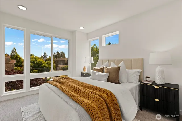 a bedroom with bed and large window