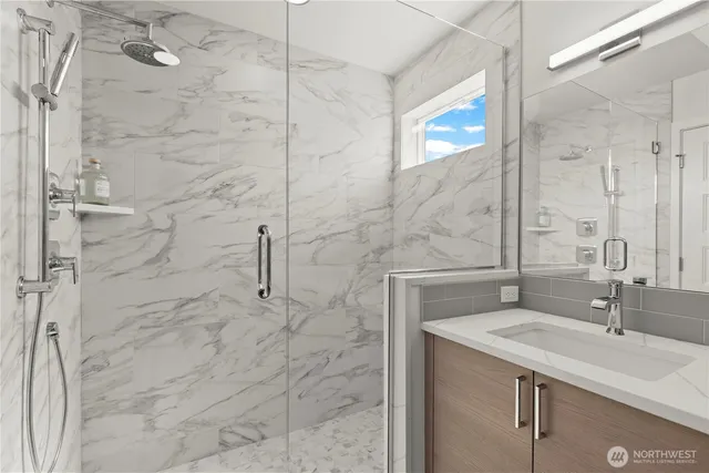 a bathroom with a sink and shower