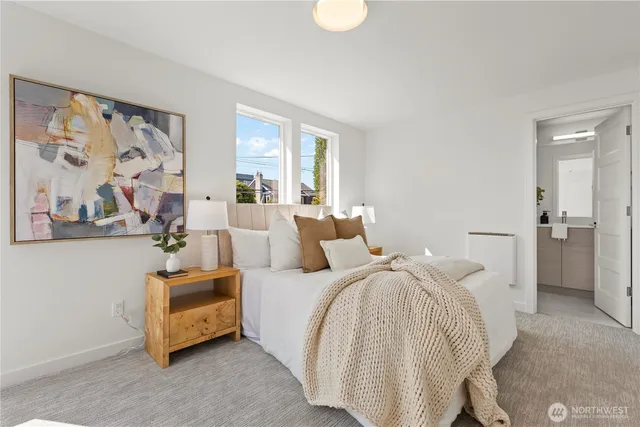 a spacious bedroom with a bed and a painting on the wall