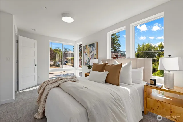 a bedroom with bed and large window