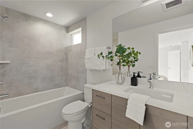 a bathroom with a sink a toilet and a bathtub