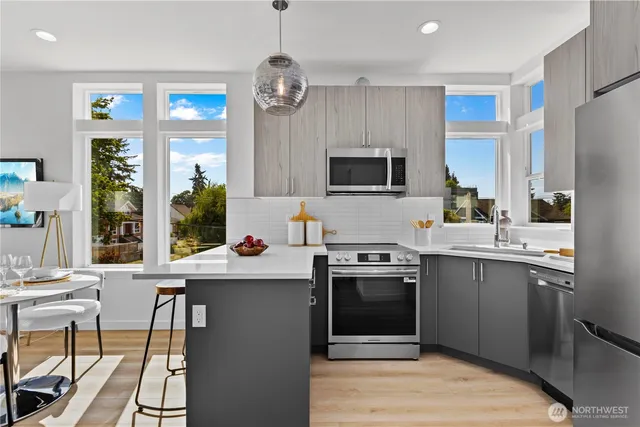 a kitchen with cabinets a sink and stainless steel appliances