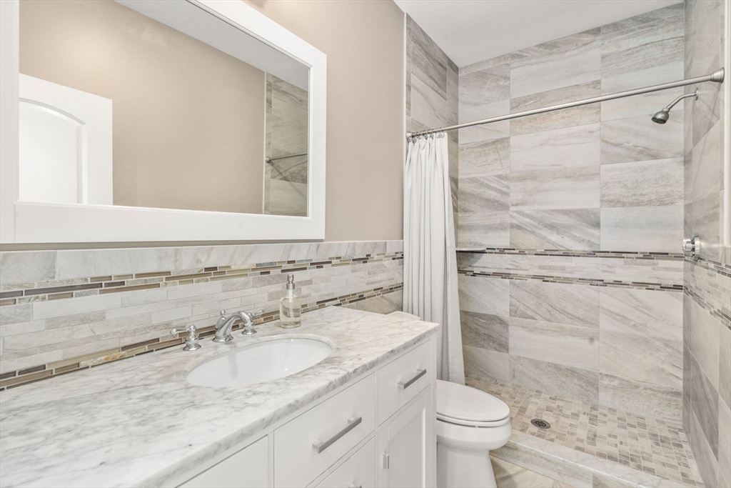97 Great Plain Avenue Needham, MA 02492 - Photo 17 of 40 a bathroom with a granite countertop sink toilet and shower
