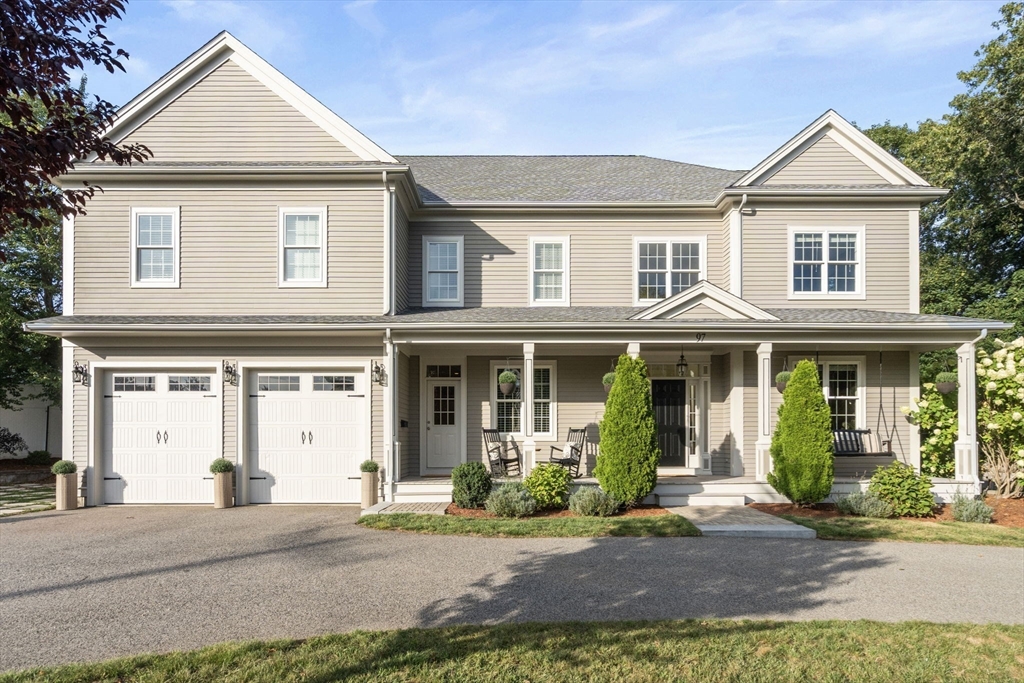 97 Great Plain Avenue Needham, MA 02492 - Photo 37 of 40 a front view of a house with a yard and potted plants