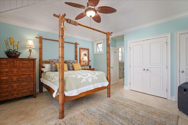 a bedroom with a bed and glass windows